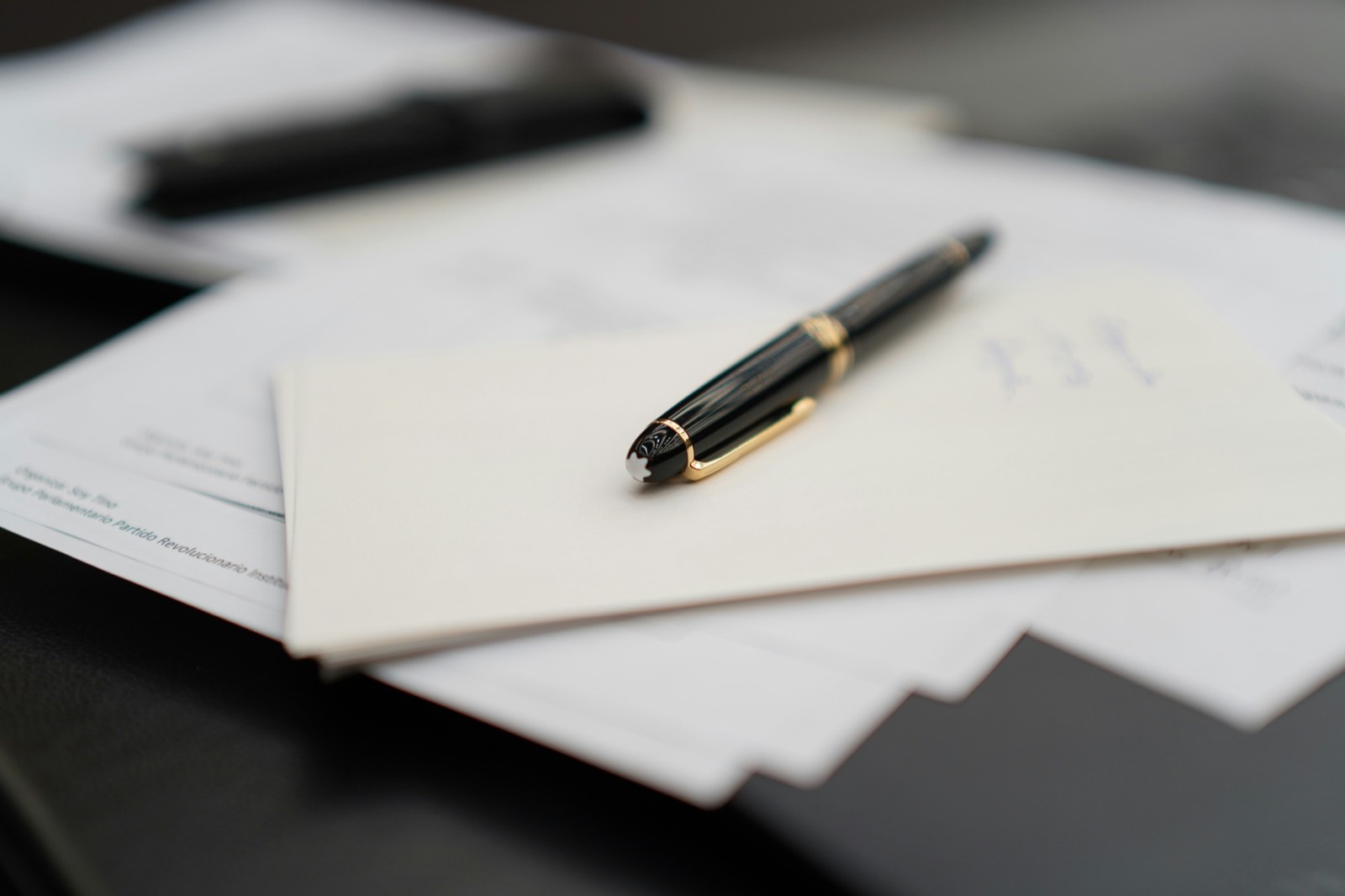 A fountain pen resting on business documents